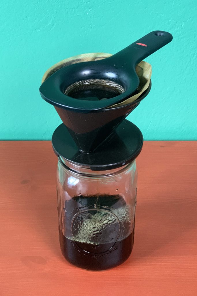 Straining the DIY Cold Brew Concentrate with a mesh strainer, filter and #2 coffee cone (view from side)