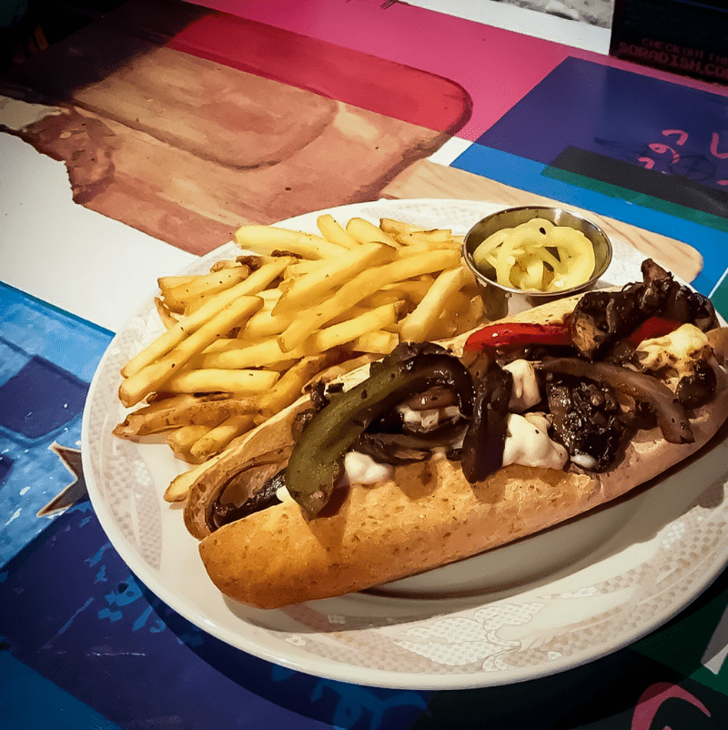 Photo of a Mushroom Cheesesteak Sandwich, topped with Vegan Provolone.